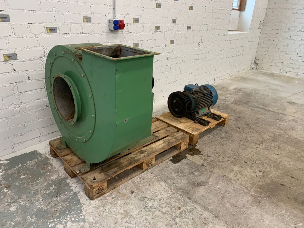 alt="Used industrial fan with electric motor"